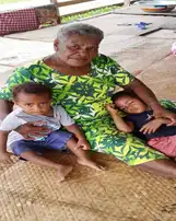 A grandmother shields her grandchildren as a full picture of a healthy, loving family.