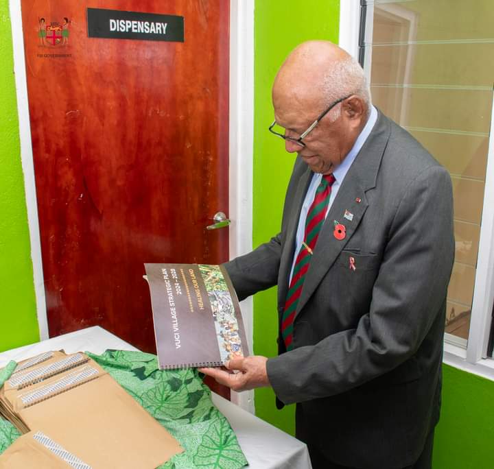 Prime Minister Sitiveni Rabuka reads through the new Vuci Village Strategic Plan 2024-2028