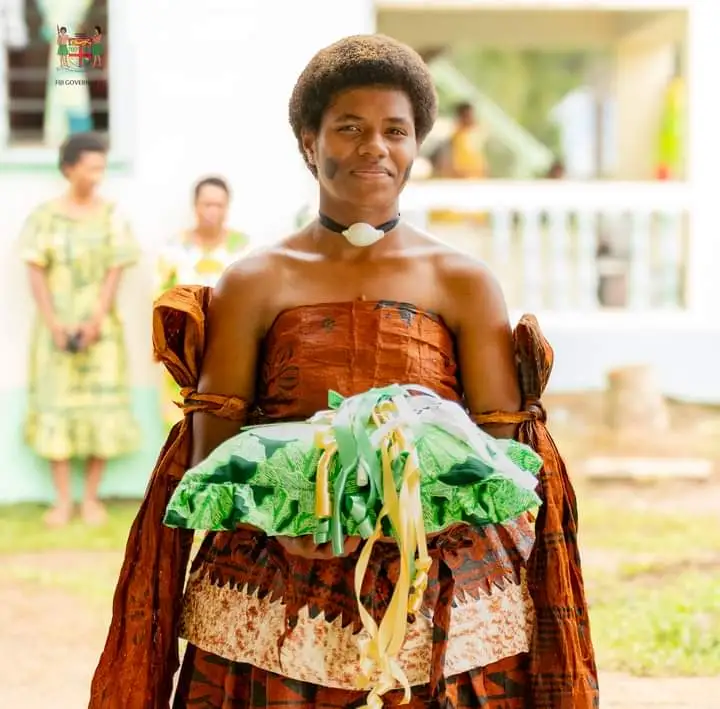 A Vuci maiden heralds the new beginning signified by the opening of her village's new meeting place.