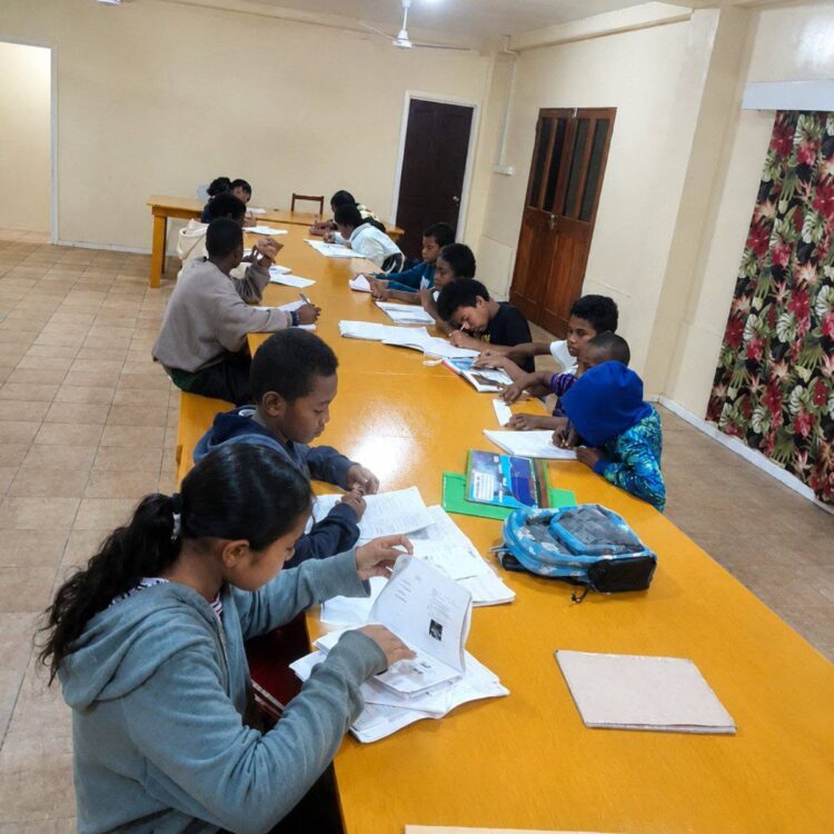 Secondary school students keep warm while preparing for midterms.